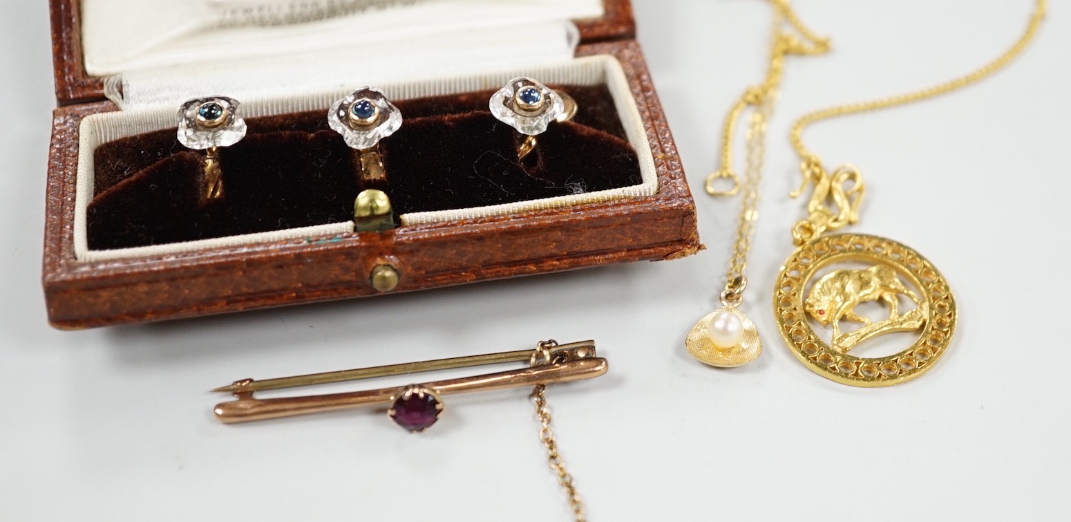 A small collection of jewellery to include a yellow metal Taurus medallion, a small yellow metal and gem set bar brooch, a 9ct gold and cultured pearl pendant and an Austro Hungarian yellow metal, paste and cabochon set